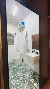 a bathroom with a toilet and a sink at Favos Bích Động in Vũ Lâm +23 photos