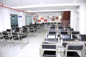a room full of chairs and tables and a classroom at Infinity Hotel in Rajkot