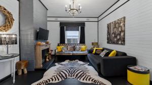 a living room with a zebra rug on the floor at Le Petit Chateau in Medlow Bath