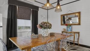 a dining room with a wooden table and a mirror at Le Petit Chateau in Medlow Bath +15 photos