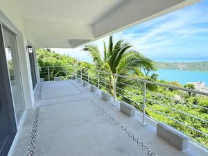 a balcony of a house with a view of the ocean at Rincon Frente al mar in Acapulco