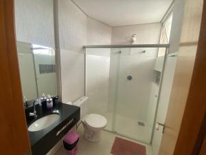 a bathroom with a shower and a toilet and a sink at Lagoa Flats in Lagoa Santa