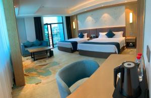 a hotel room with two beds and a table at SENNA SUNSHINE INTERNATIONAL HOTEL in Sihanoukville +91 photos