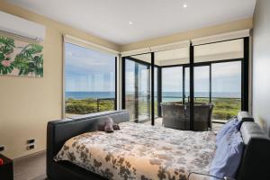 a bedroom with a bed and a view of the ocean at Amazing Ocean Views with Spa in Surf Beach