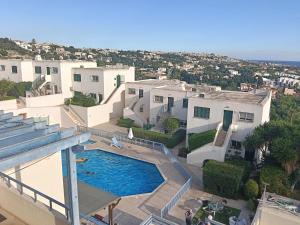 an aerial view of a house with a swimming pool at Two BR Sea View with Balcony and Pool Paphos in Khlorakas