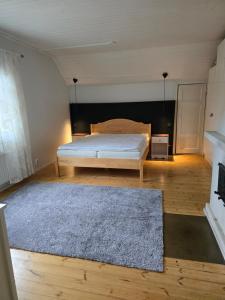 a bedroom with a bed and a rug at Linnansalmi Lakeside Villa with Sauna in Savonlinna