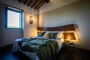 a bedroom with a large bed and a window at Agriturismo Podere Pietraluna in Città di Castello +58 photos