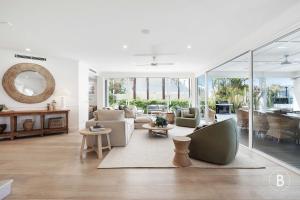 a living room with a couch and a table at Lucy - Noosa - Noosaville in Noosaville +32 photos