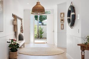 a living room with a hallway with a door at Lucy - Noosa - Noosaville in Noosaville
