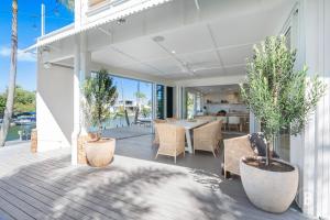 a house with a porch with a table and chairs at Lucy - Noosa - Noosaville in Noosaville