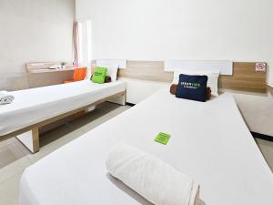 a hospital room with two beds and a window at Urbanview Java Living Sigura Gura in Betek