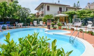 a pool at a hotel with chairs and tables at Hotel Benaco in Sirmione