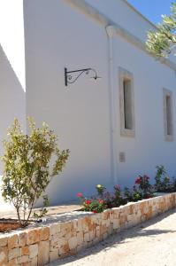 a white building with a sign on the side of it at Agriturismo Santo Stefano - Monopoli in Monopoli