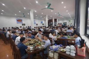 a large group of people sitting at tables eating food at Bích Giản Tràng An in Nguyên Ngoại
