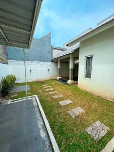 an outside view of a house with a yard at Arcovella House in Cikarang