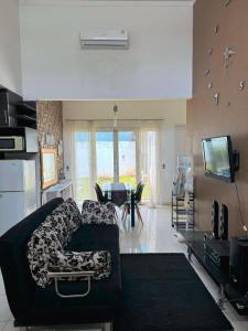 a living room with a couch and a television at Arcovella House in Cikarang