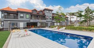a house with a swimming pool in front of a house at Taean janggog pension in Taean