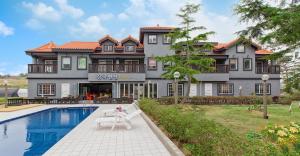 a large house with a swimming pool in front of it at Taean janggog pension in Taean +4 photos