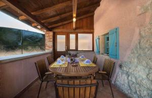 a dining room with a wooden table and chairs at Holiday Home Sandra in Sveti Lovreč Pazenatički