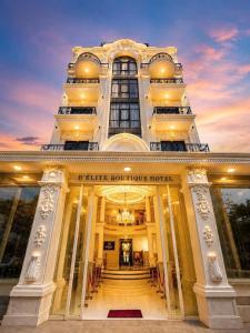 a large building with a staircase in front of it at D'Élite Boutique Hotel Dĩ An in Dĩ An