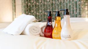 a group of three bottles sitting on top of a bed at Center Hotel Mihara in Mihara