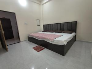 a bedroom with a large bed in a room at Pramod Residency in Chitrakoot