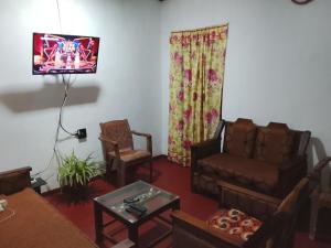 a living room with a couch and a chair at Duleni villa in Haldummulla