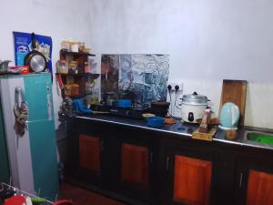 a kitchen with a counter top and a refrigerator at Duleni villa in Haldummulla