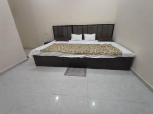 a large bed in a room with at Pramod Residency in Chitrakoot +3 photos