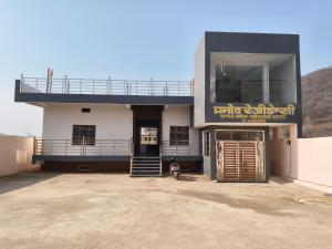 a building with a sign that reads third exit at Pramod Residency in Chitrakoot