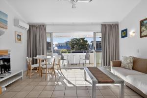 a living room with a couch and a table at Noosa Parade Holiday Inn in Noosa Heads