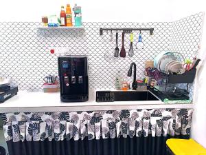 a kitchen with a sink and a counter top at Adeeb Homestay in Tumpat
