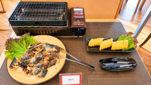 a table with a plate of food and a grill at Center Hotel Mihara in Mihara +21 photos