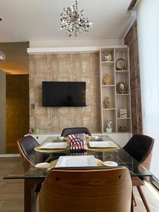 a dining room with a table and chairs and a television at Apartment luxury and comfort in Monterrey