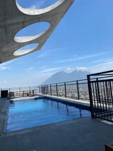 a swimming pool with a view of the ocean at Apartment luxury and comfort in Monterrey