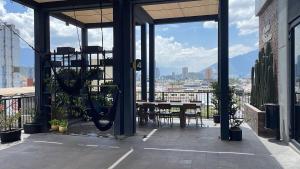 a patio with a table and a view of the city at Apartment luxury and comfort in Monterrey