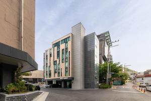 a tall building on a city street at Bliss Hotel Myeongdong in Seoul