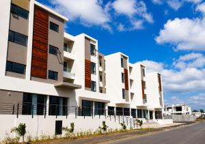 a row of white apartment buildings on a street at Studio 213 - Ebene Square in Ebene