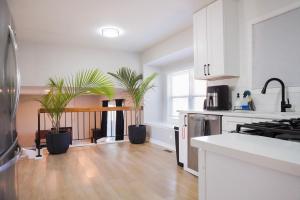 a kitchen with two potted plants in a room at Jacuzzi Cul de Sac Home in Country Club Hills
