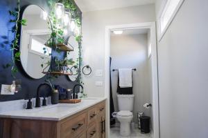 a bathroom with a sink and a mirror at Jacuzzi Cul de Sac Home in Country Club Hills +57 photos
