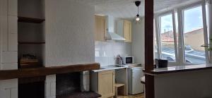 a kitchen with a sink and a window and a counter at Marans in Marans