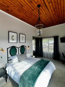 a bedroom with a large bed with a wooden ceiling at Welgemoed Villa in Bellville +75 photos