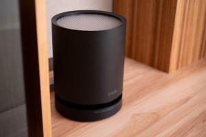 a black speaker is sitting on a wooden floor at Tousumi in Fukuoka +11 photos