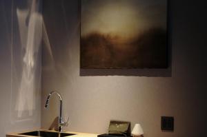 a bathroom with a sink and a picture on the wall at Tousumi in Fukuoka