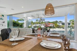 a dining room with a table with wine glasses at Key Court 17 in Noosa Heads +21 photos