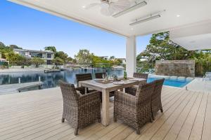 a dining room with a table and chairs on a deck at Key Court 17 in Noosa Heads