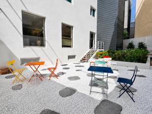 a group of colorful chairs sitting on a patio at Link B Hotel in Busan