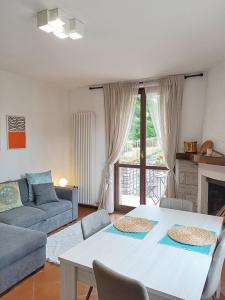 a living room with a table and a couch at Casa Anna in Lierna +15 photos