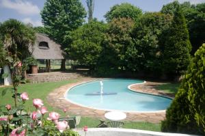 a swimming pool with a person in the middle at Rawdons Hotel & Brewery in Nottingham Road