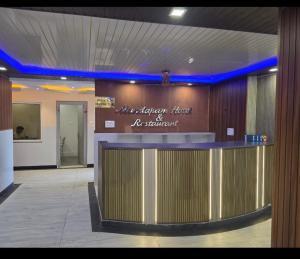 a lobby with a bar with a sign on it at Mandapam Hotel & Restaurant in Dhanbād